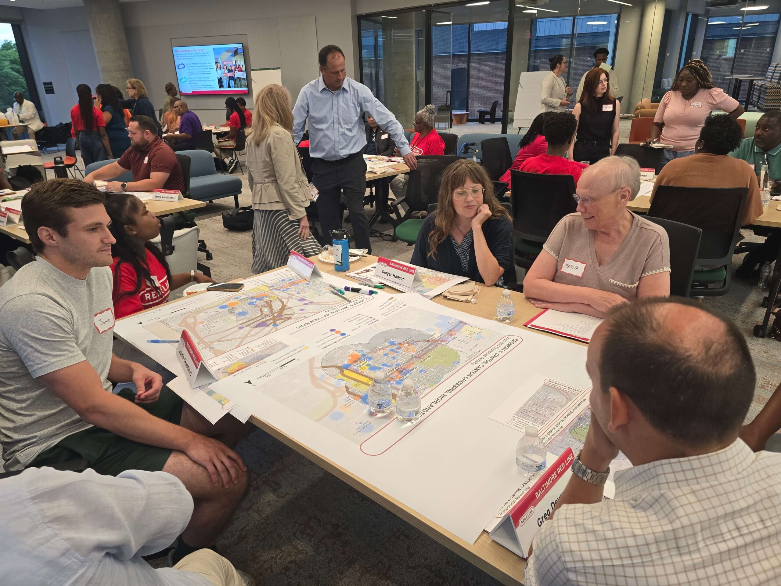 July 16, 2025 CAT Meeting people around tables with maps working